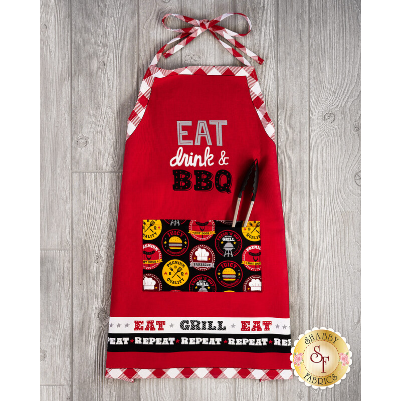 The adorable Peace, Love & BBQ Apron on wood background