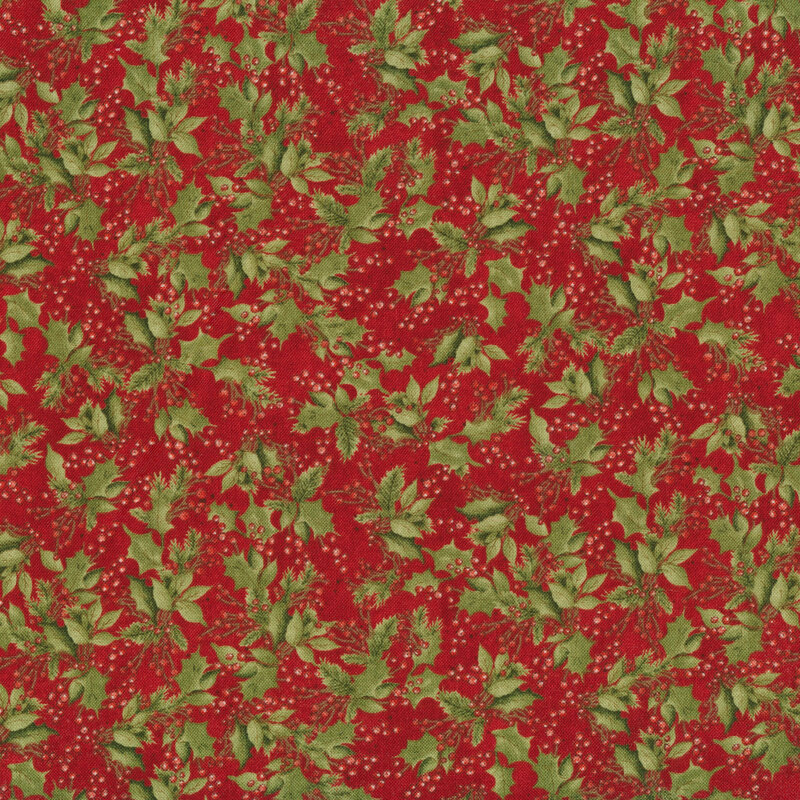 Tossed holly and berries on a red background